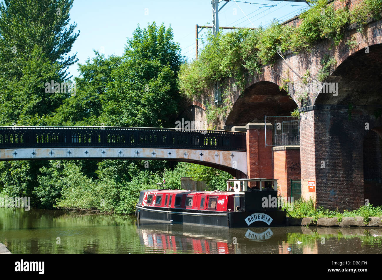 Longboat su Bridgewater Canal vicino al viadotto ferroviario, Manchester, Regno Unito Foto Stock