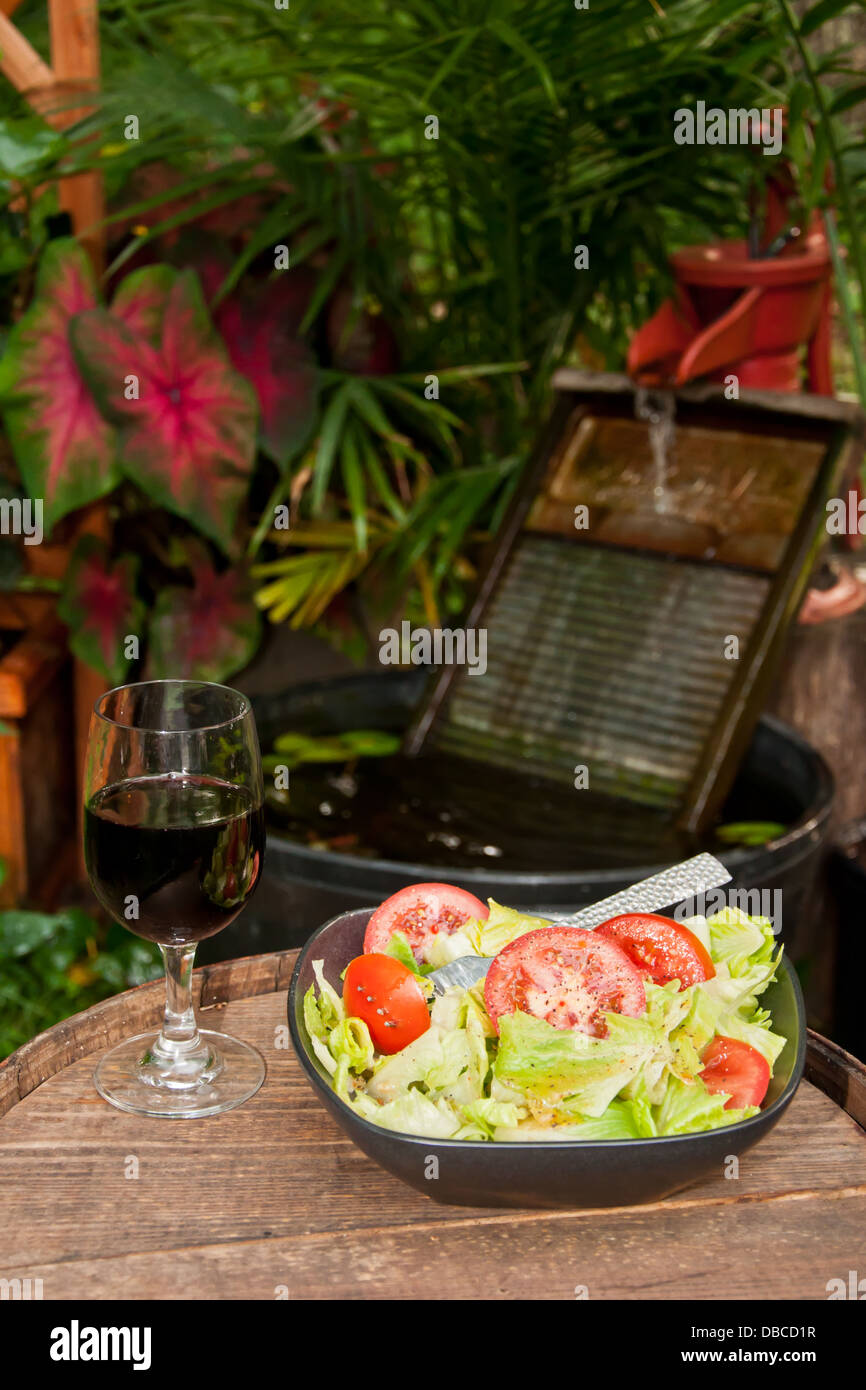 Insalata e un bicchiere di vino Foto Stock
