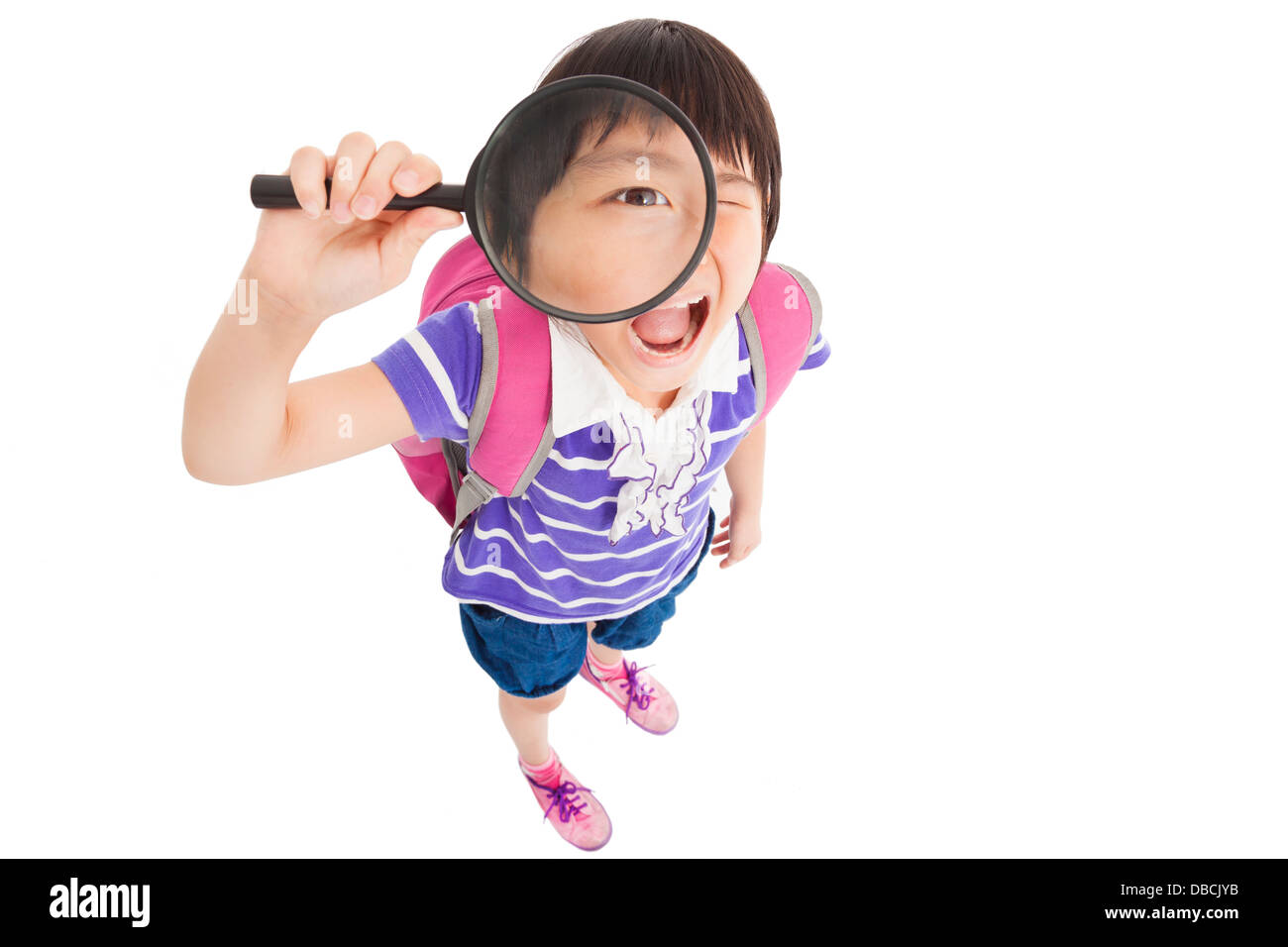 Scuola felice bambina holding magnifier Foto Stock