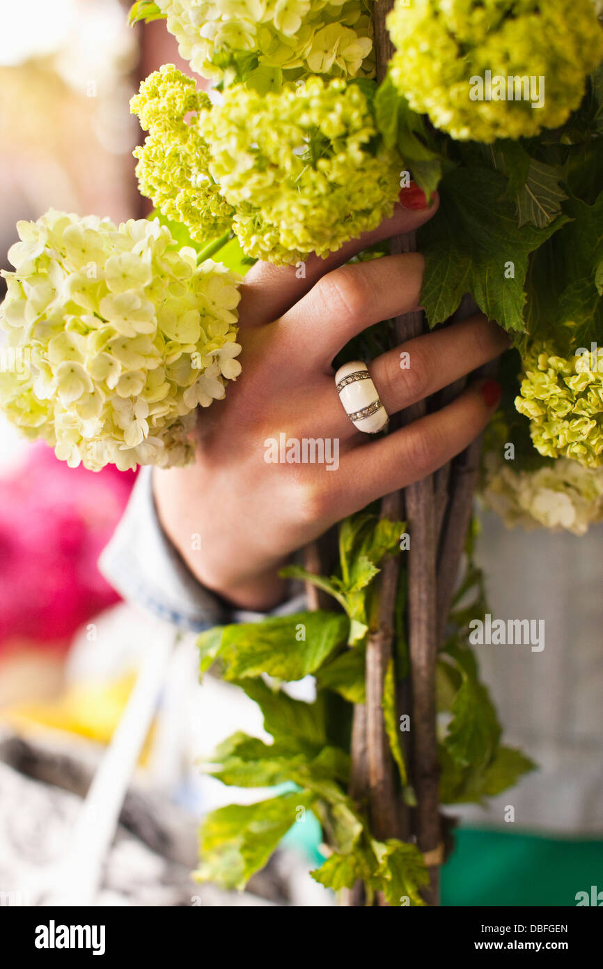 La donna caucasica holding bouquet di fiori Foto Stock
