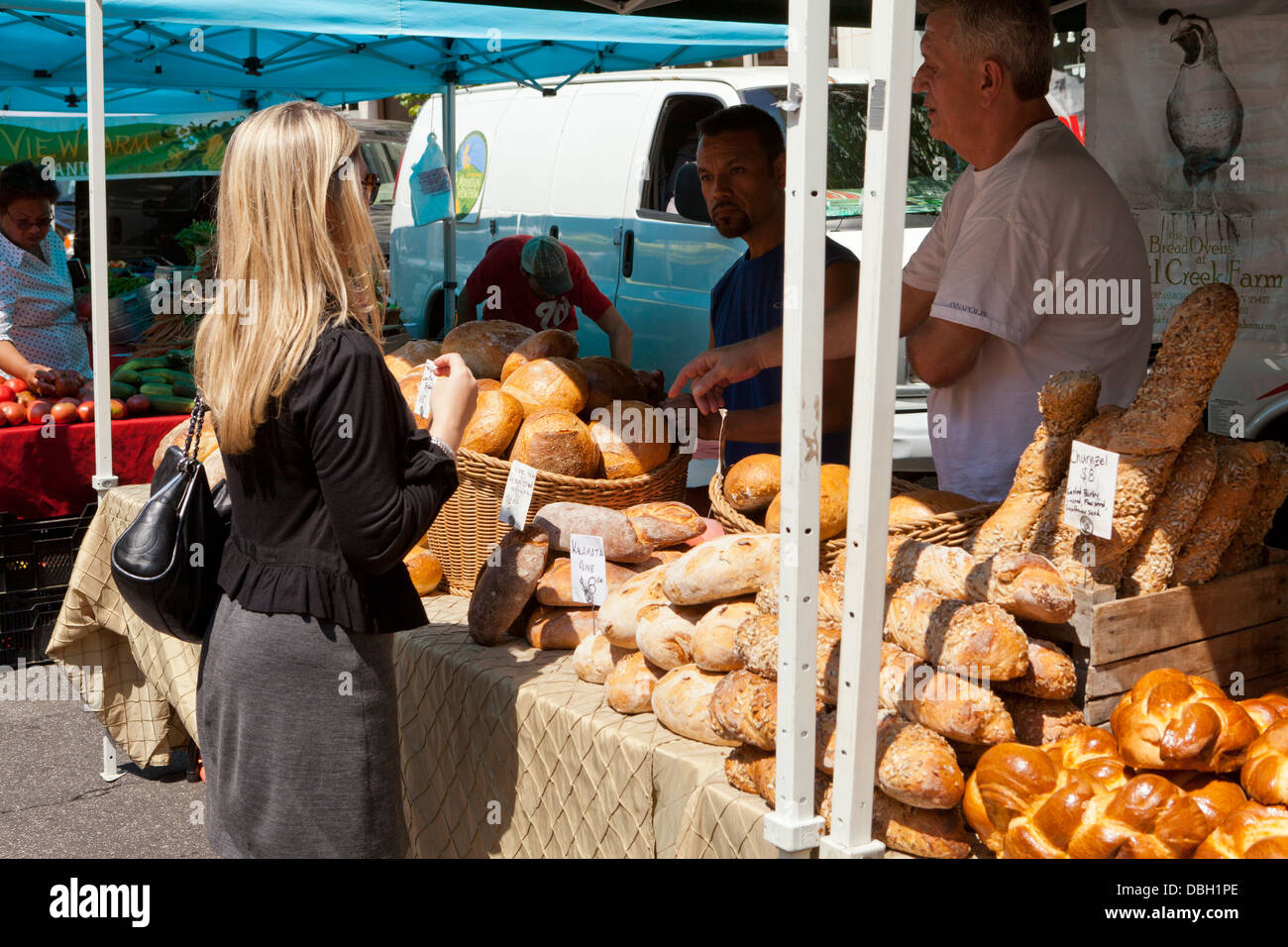 Donna acquisto di focacce di pane al mercato degli agricoltori - USA Foto Stock