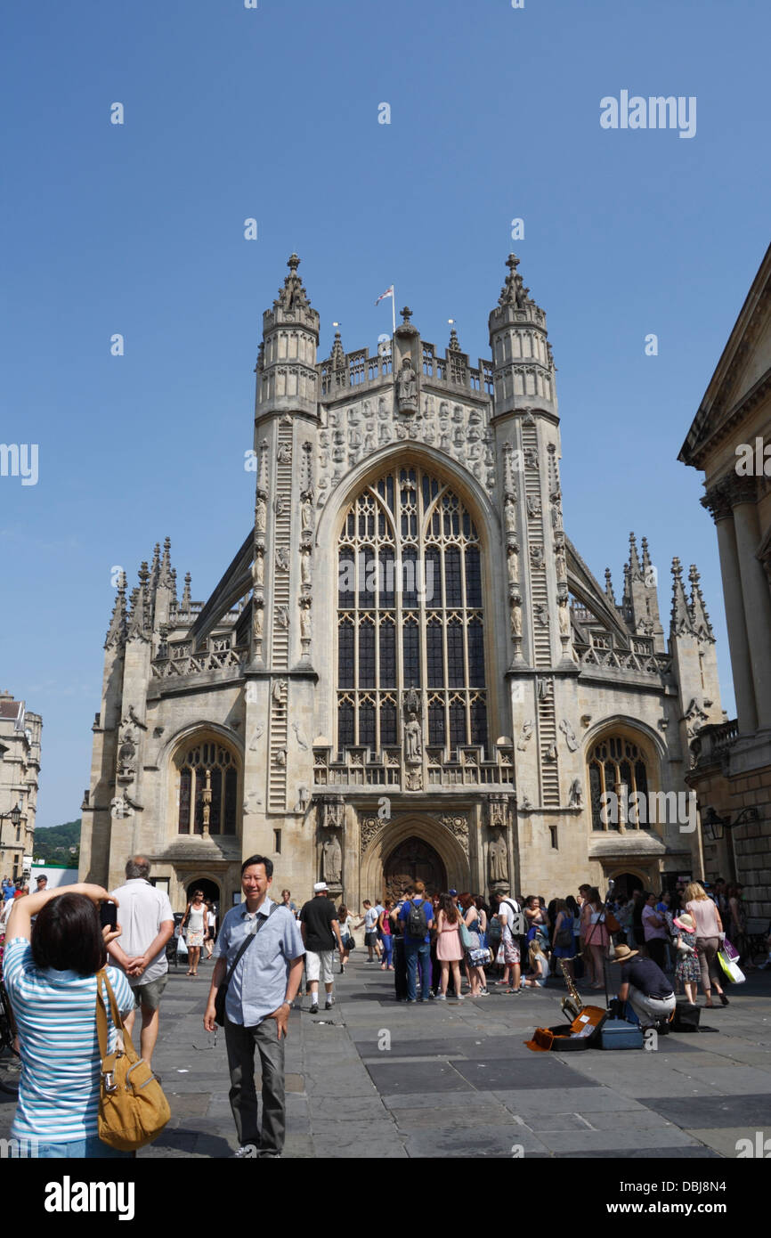 I turisti che si trovano di fronte alla chiesa dell'abbazia di Bath in Inghilterra, una destinazione turistica patrimonio dell'umanità, iniziano alla fine della passeggiata di cotswold Way Foto Stock