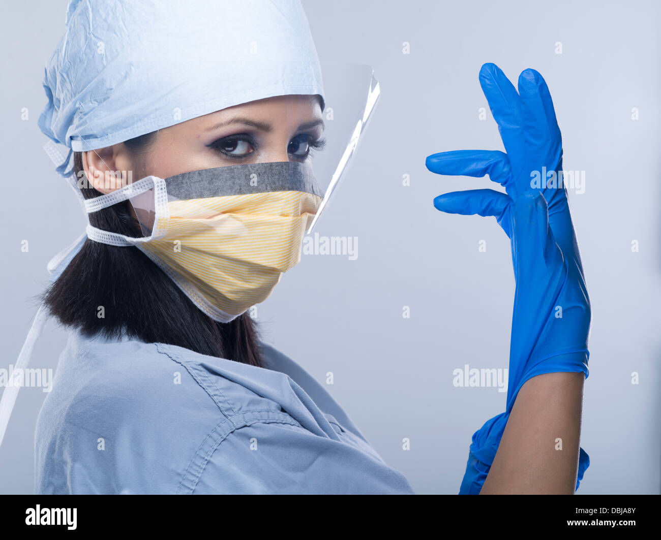 Femmina / infermiere Medico Chirurgo / indossando scrubs con guanti e maschera Foto Stock