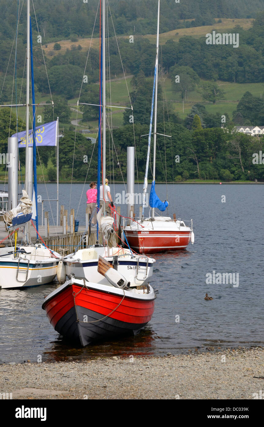 Coniston molo di lancio con la barca a vela e altre imbarcazioni ormeggiate o spiaggiata, Coniston Water, Parco Nazionale del Distretto dei Laghi Foto Stock