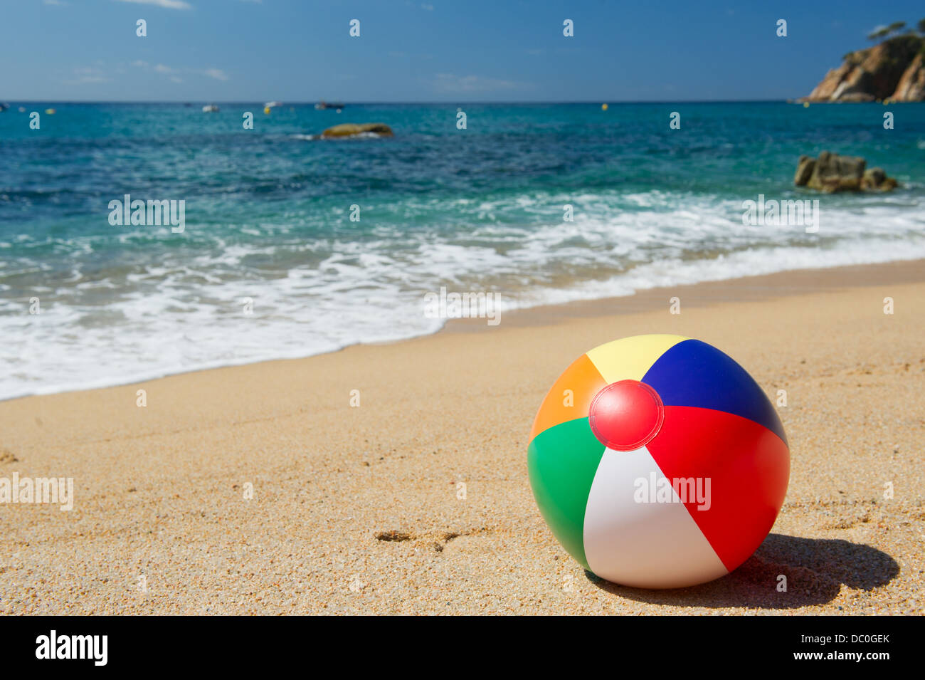 Gonfiabile di palla spiaggia in sabbia vicino alla linea di acqua presso la spiaggia di spagnolo Foto Stock