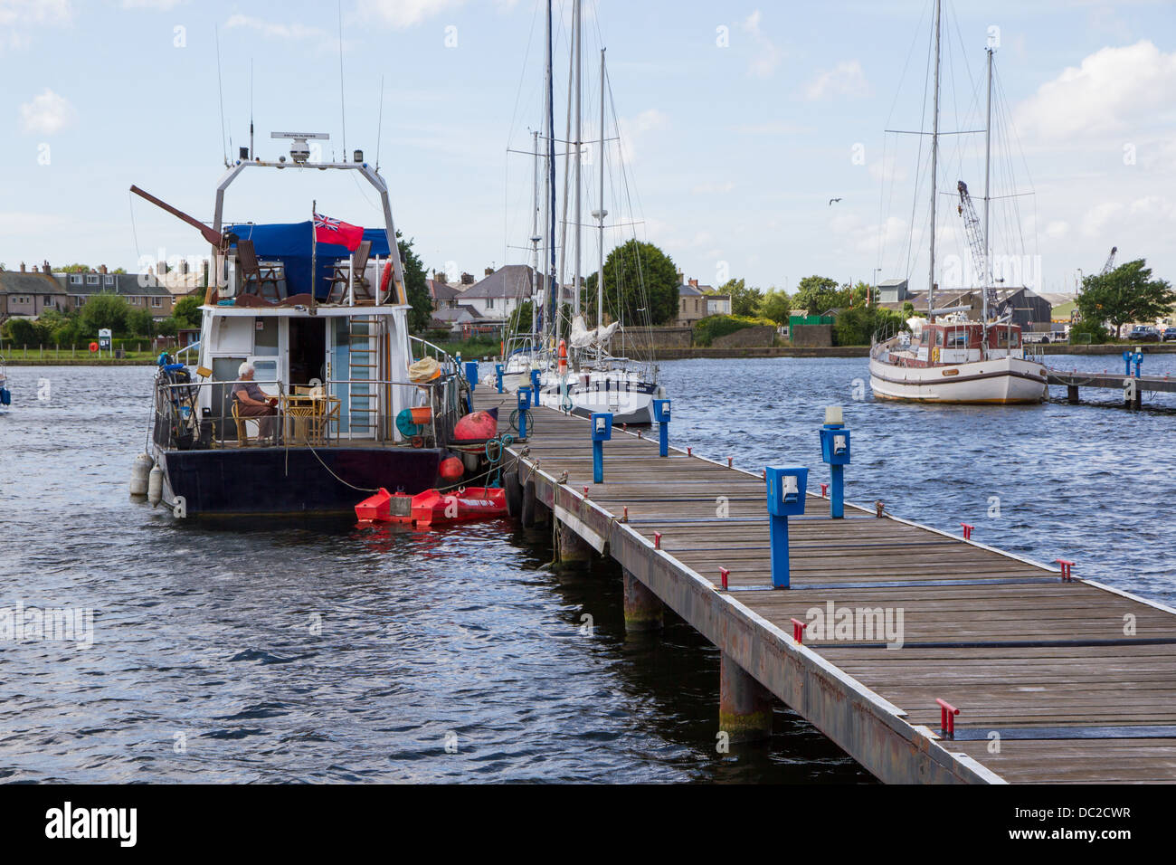 Barche ormeggiate lungo il molo al bacino Glasson, Glasson Dock, Lancaster, Lancashire. Foto Stock