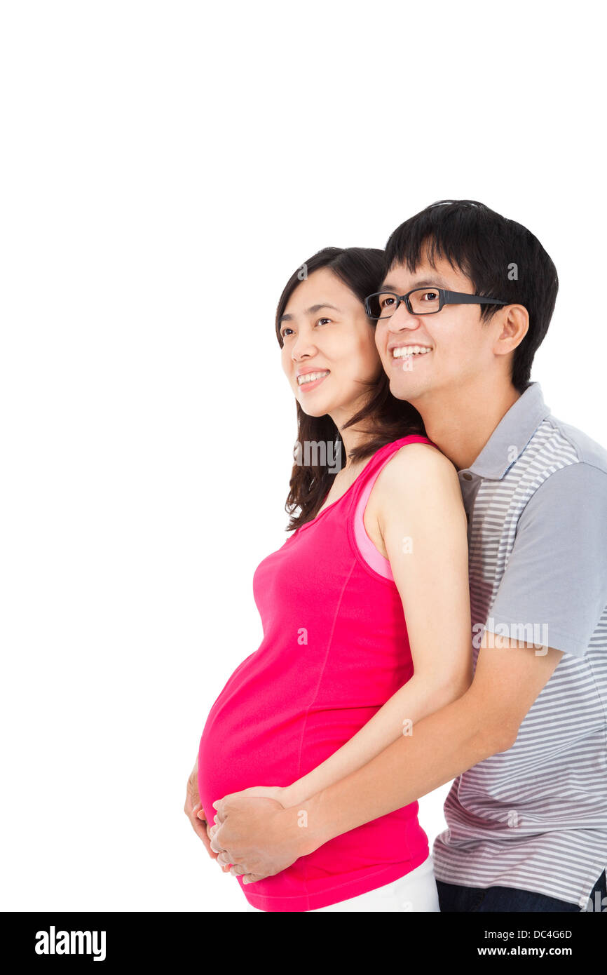 Felice la donna incinta e il marito isolato su bianco Foto Stock