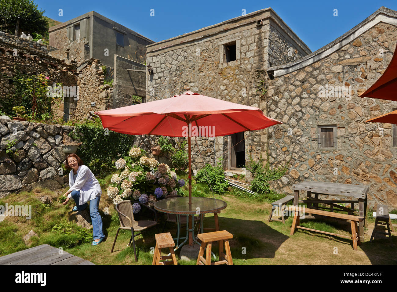 Locale Isola Beigan residente Hao-Lien Wang al di fuori della sua famiglia orientale classico stile Fujian casa di pietra. Foto Stock
