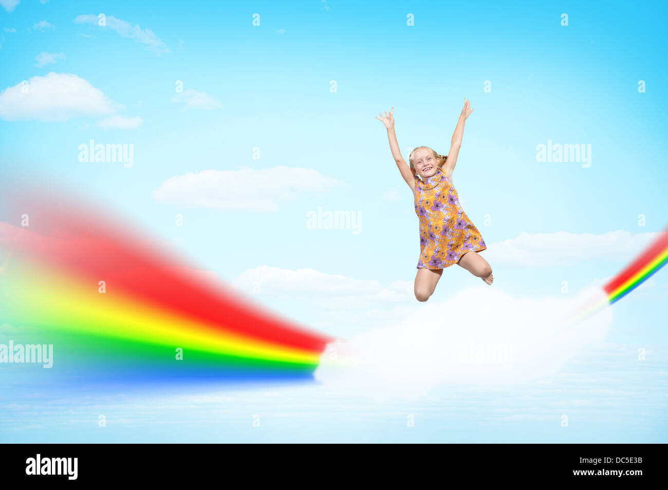 Ragazza saltando sulle nuvole e un arcobaleno Foto Stock