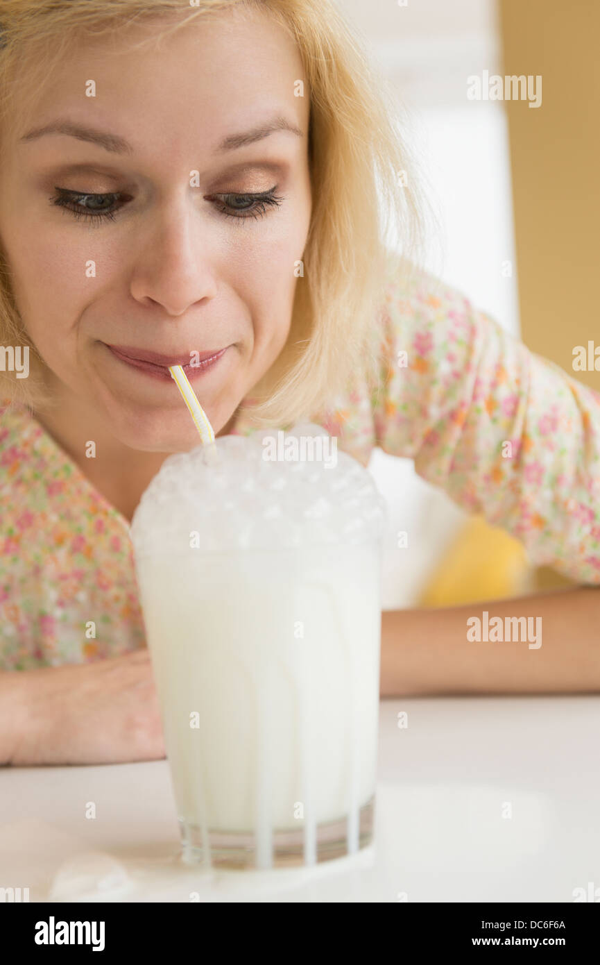Ritratto di donna a soffiare bolle nel latte Foto Stock