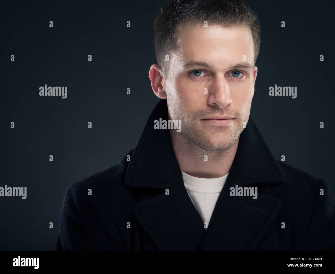 Bel uomo caucasico in t-shirt bianco e scuro pisello di lana cappotto giacca ( ) Foto Stock