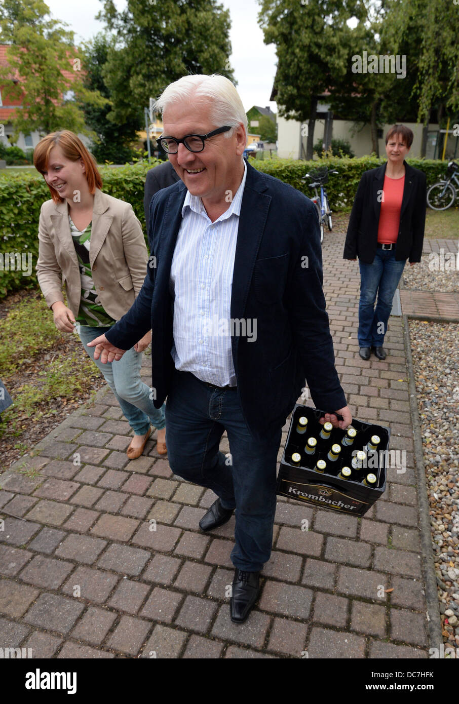Presidente della SPD del gruppo parlamentare nel Bundestag, Frank-Walter Steinmeier, porta una cassa di birra durante una campagna elettorale tour in Kreutz lordo, Germania, 11 agosto 2013. Le carte sono onm stampato su entrambi i lati, un lato che mostra il cancelliere del candidato del DOCUP Peer Steinbrueck. Foto: RALF HIRSCHBERGER Foto Stock
