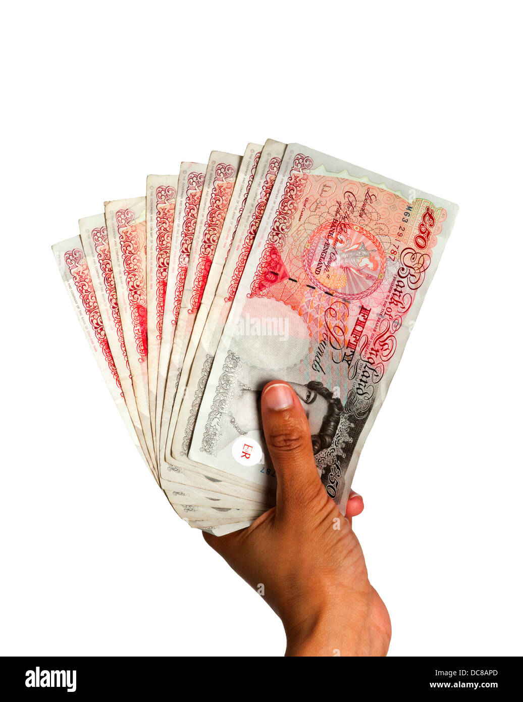 Il denaro posseduto in mano - La valuta britannica con tracciato di ritaglio Foto Stock