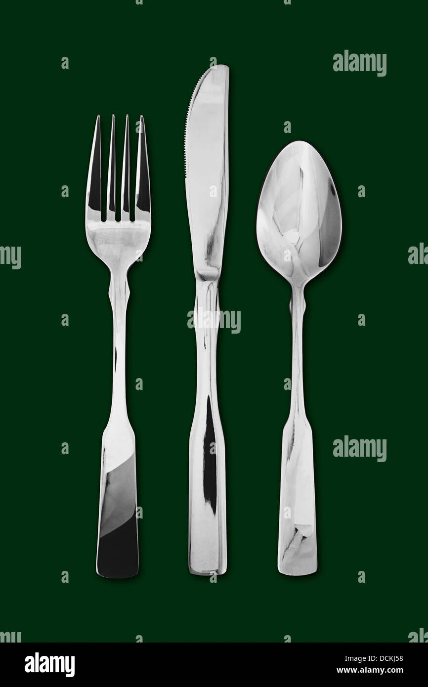 Il cibo e le bevande concetto di posate in argento e posate comprendente della forcella, un cucchiaio e un coltello Foto Stock
