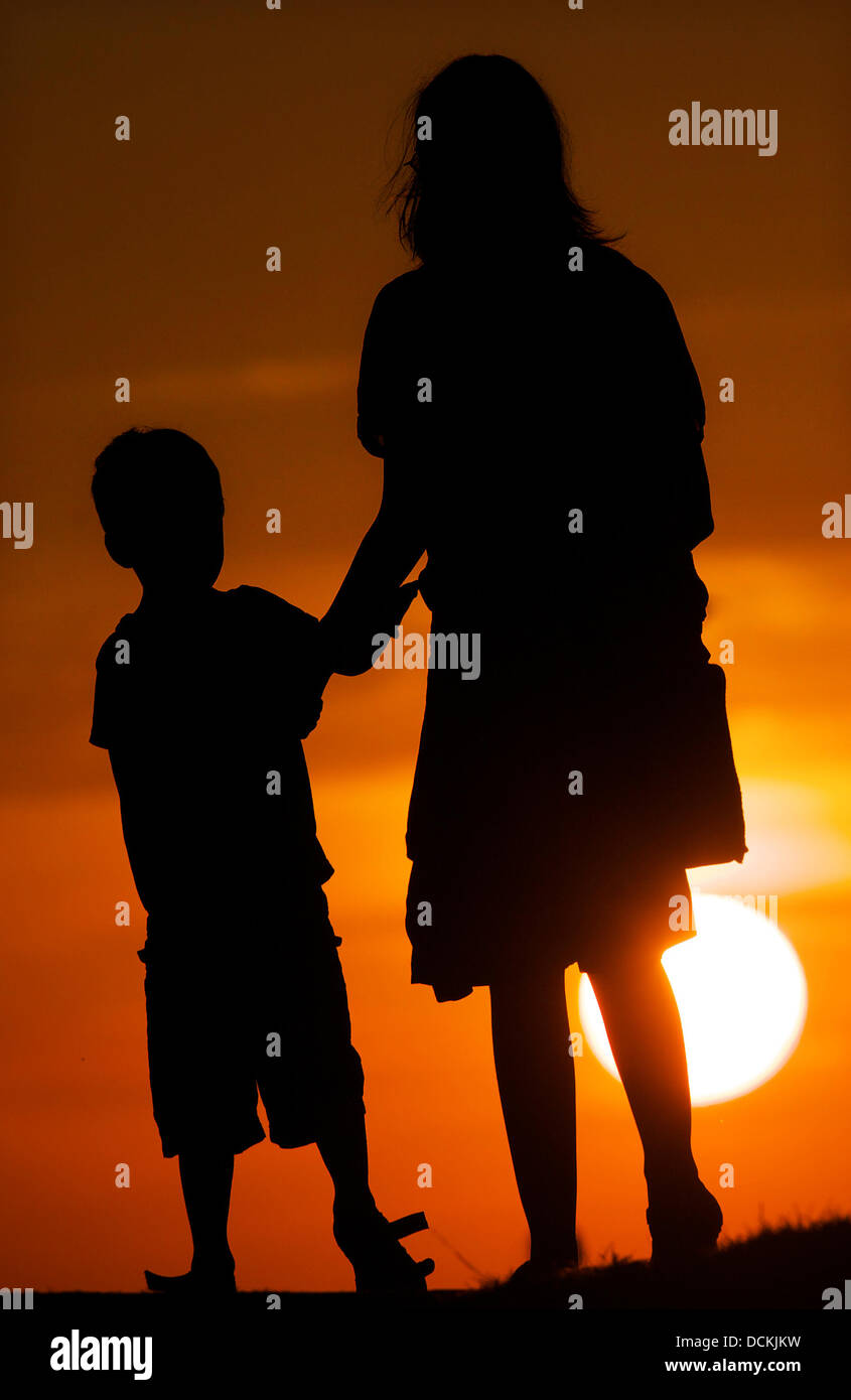 Una donna e un bambino prendere a piedi durante il tramonto sulla costa del mare Batlic nei pressi di Schoenberg/Repubblica federale di Germania il 2 agosto 2013. Foto: Fabian Stratenschulte Foto Stock