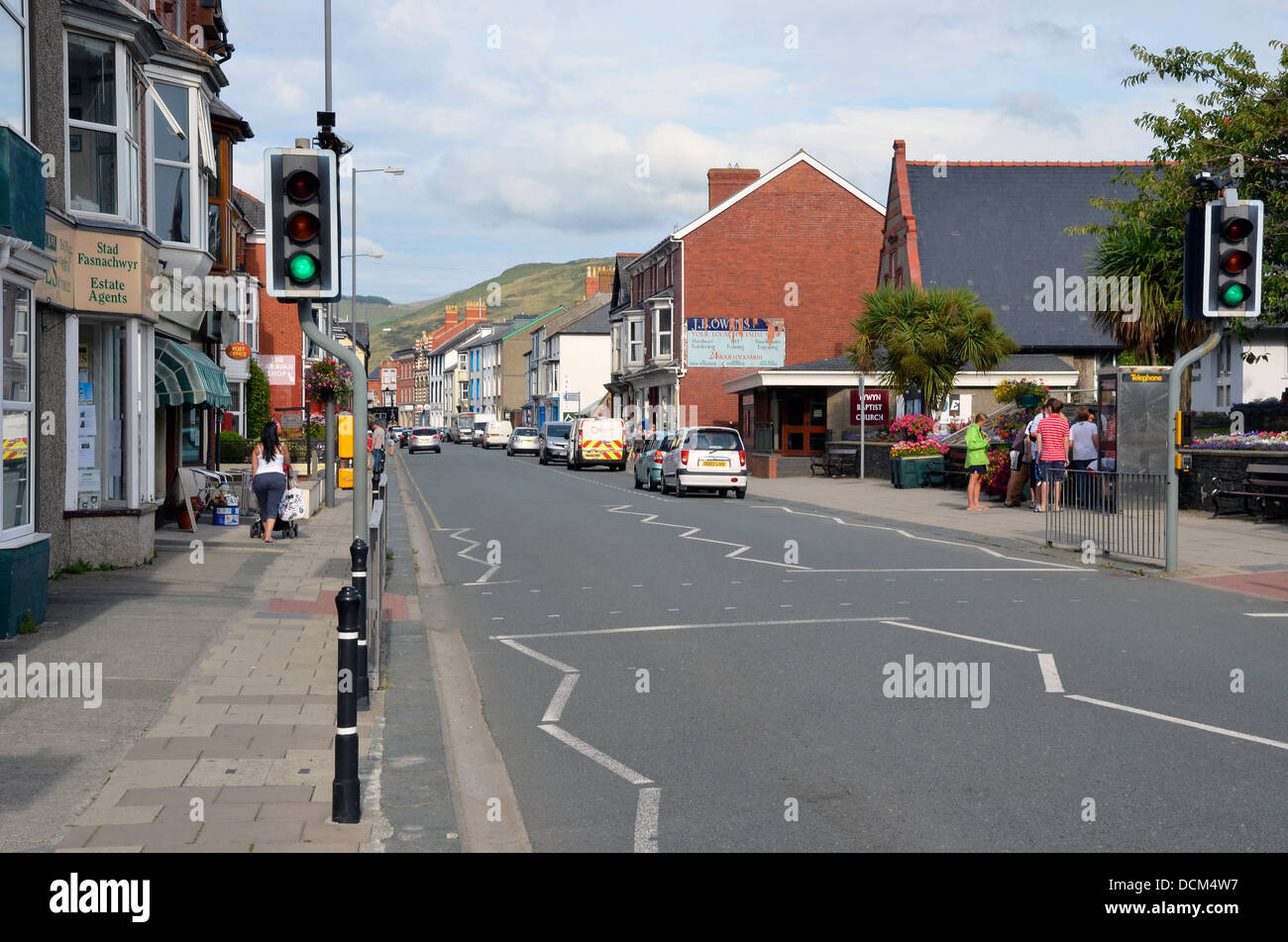 La High Street in Tywyn, Gwynedd, Galles guardando ad est verso la valle Fathew e montagne Foto Stock