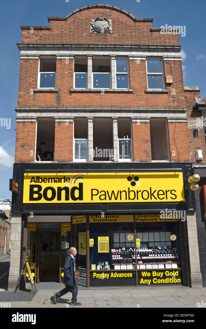 L'uomo passa un ramo di albemarle bond pawnbrokers in Hammersmith, a ovest di Londra - Inghilterra Foto Stock