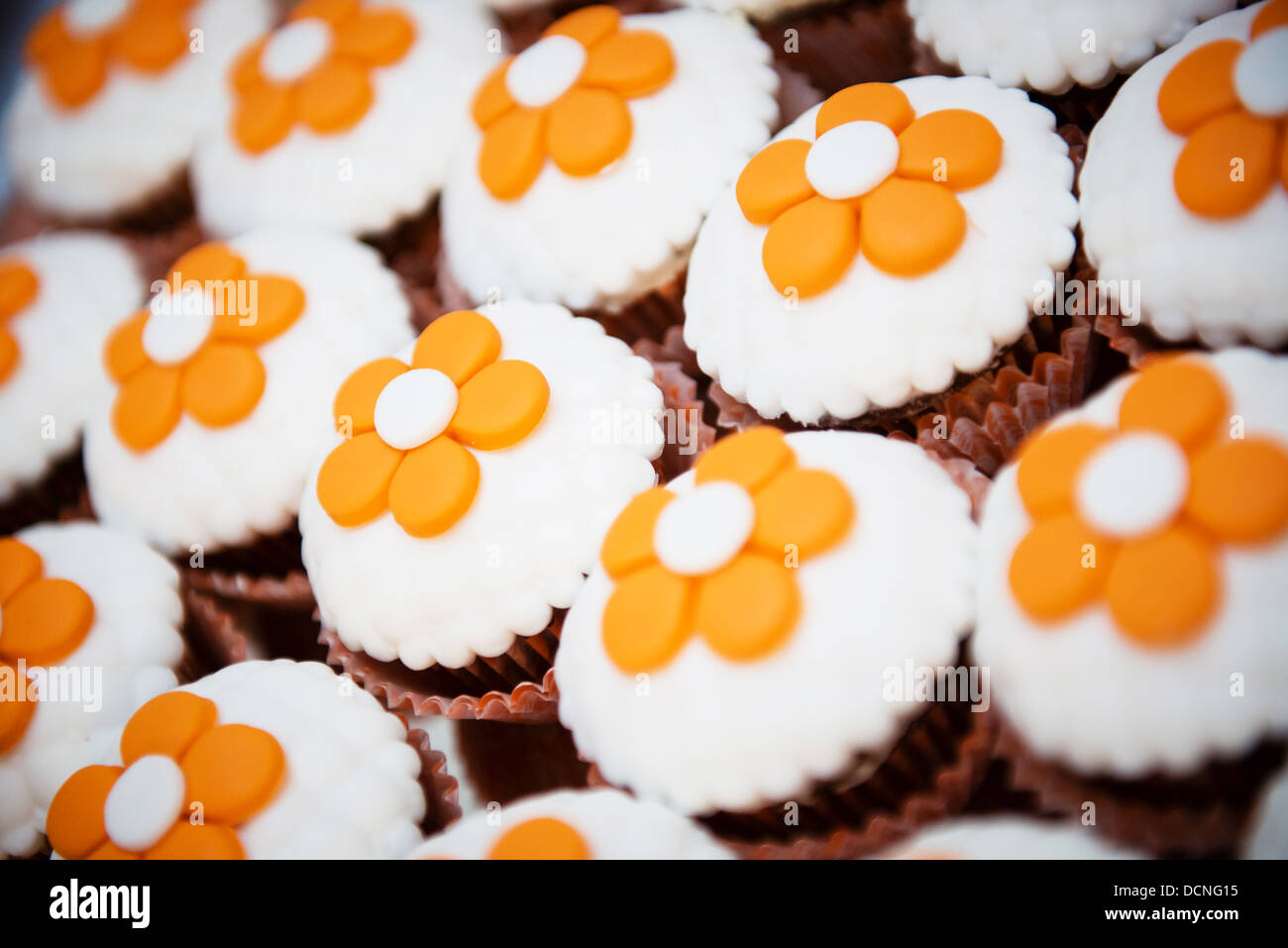 Deliziosi tortini di cioccolato con fiori arancione sulla parte superiore Foto Stock
