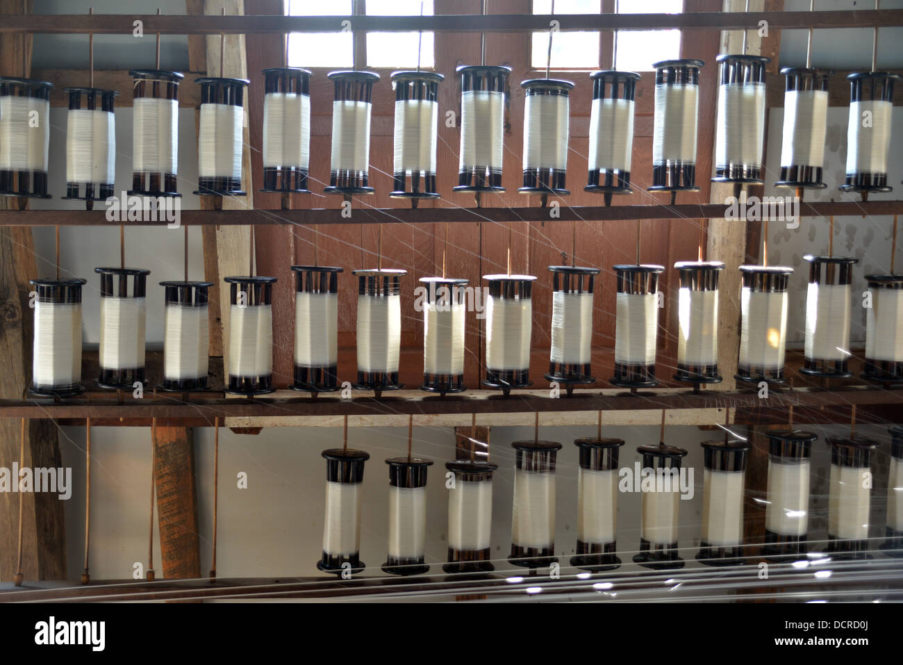 Rotoli di filo sono la filatura in un mulino di tessitura sul Lago di Inke Foto Stock