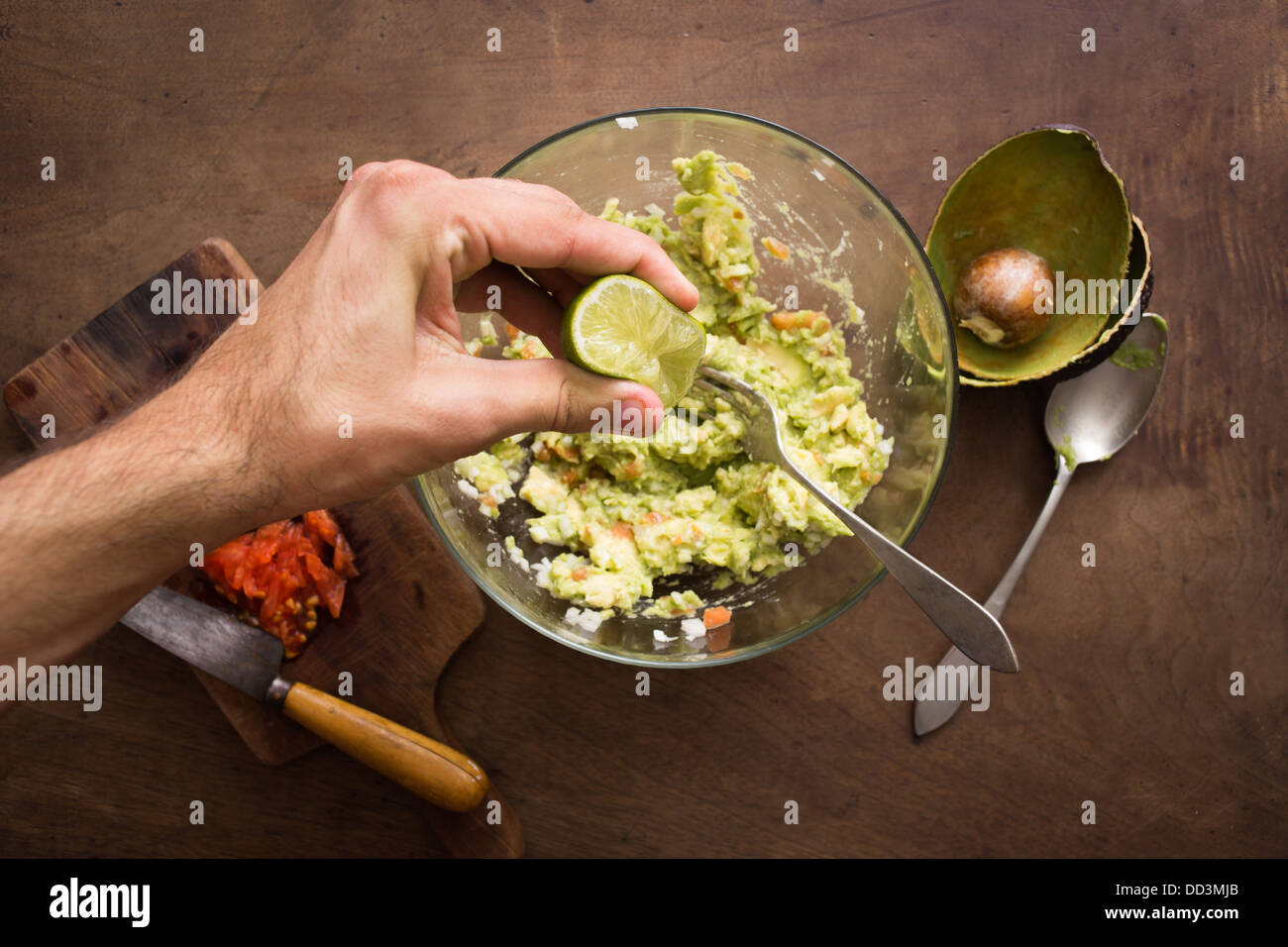 La spremitura di lime sul guacamole mix panoramica Foto Stock