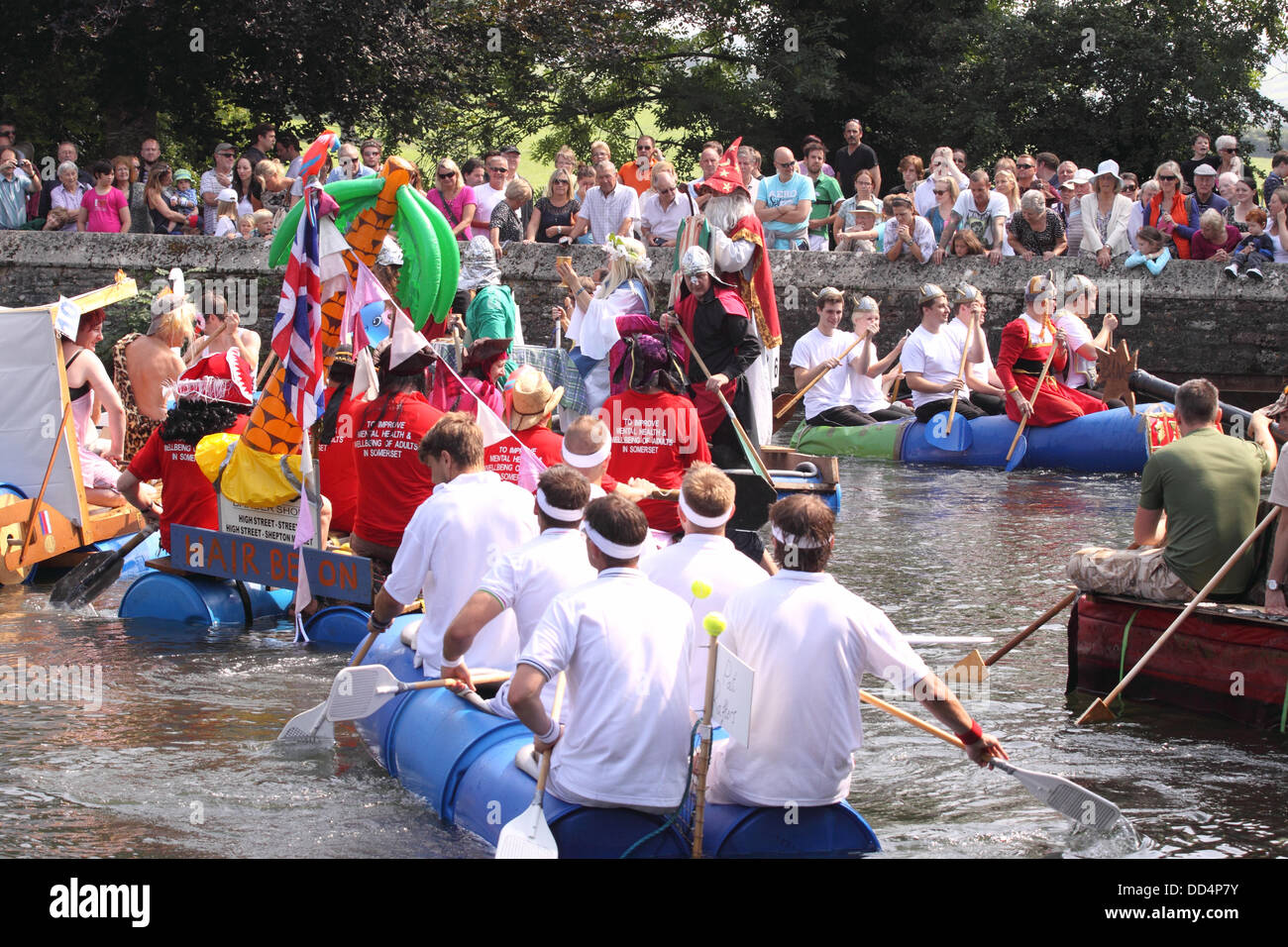 Pozzetti, Somerset, Regno Unito a Ferragosto Moat Boat Race a Wells Somerset REGNO UNITO - concorrenti in casa paddle zattere lungo il Palazzo dei Vescovi fossato Foto Stock