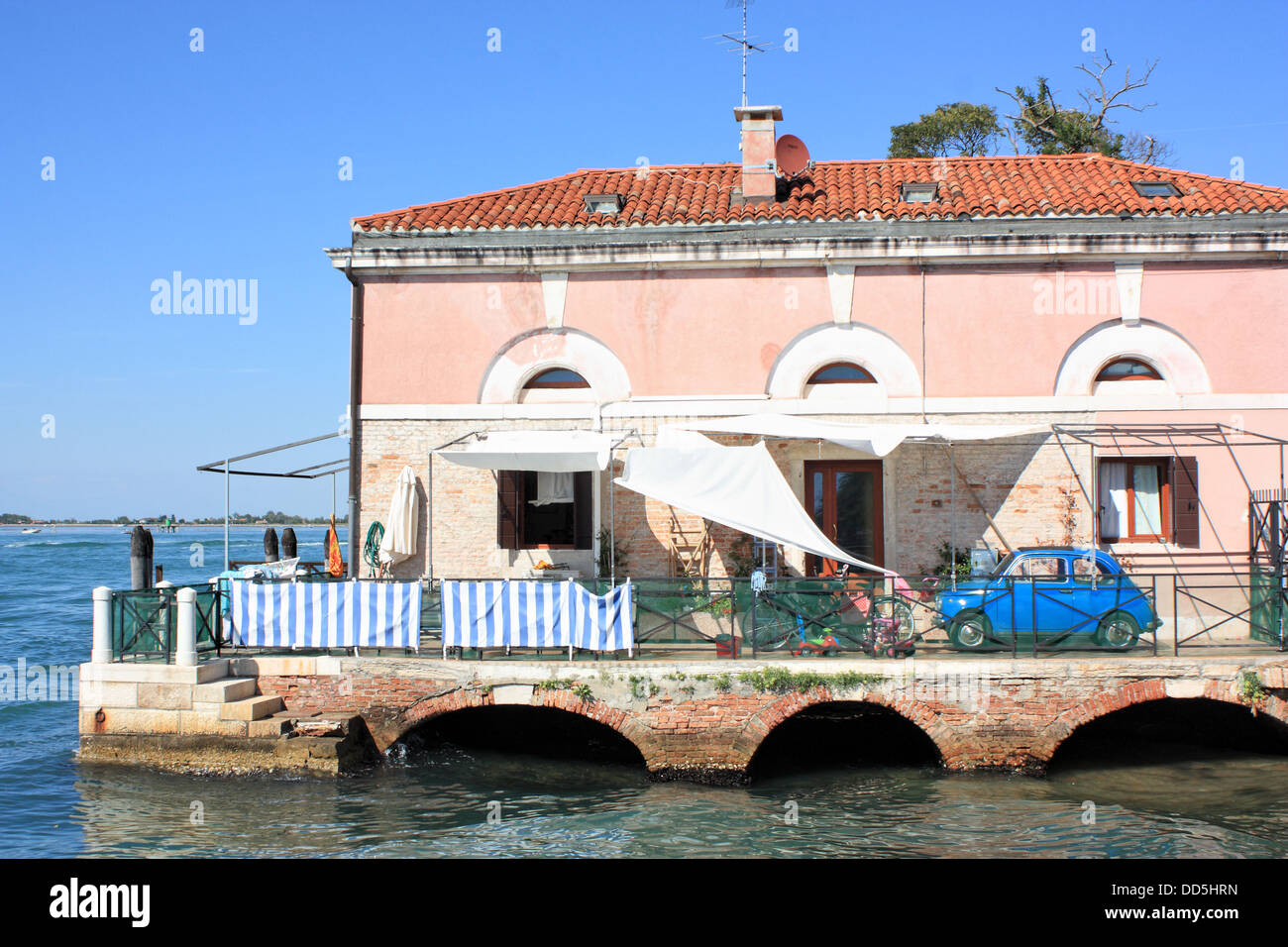 Su acqua costruire la casa a lato della laguna di isola di Lido con una vecchia FIAT 500 parcheggio presso la terrazza, Venezia, Italia Foto Stock