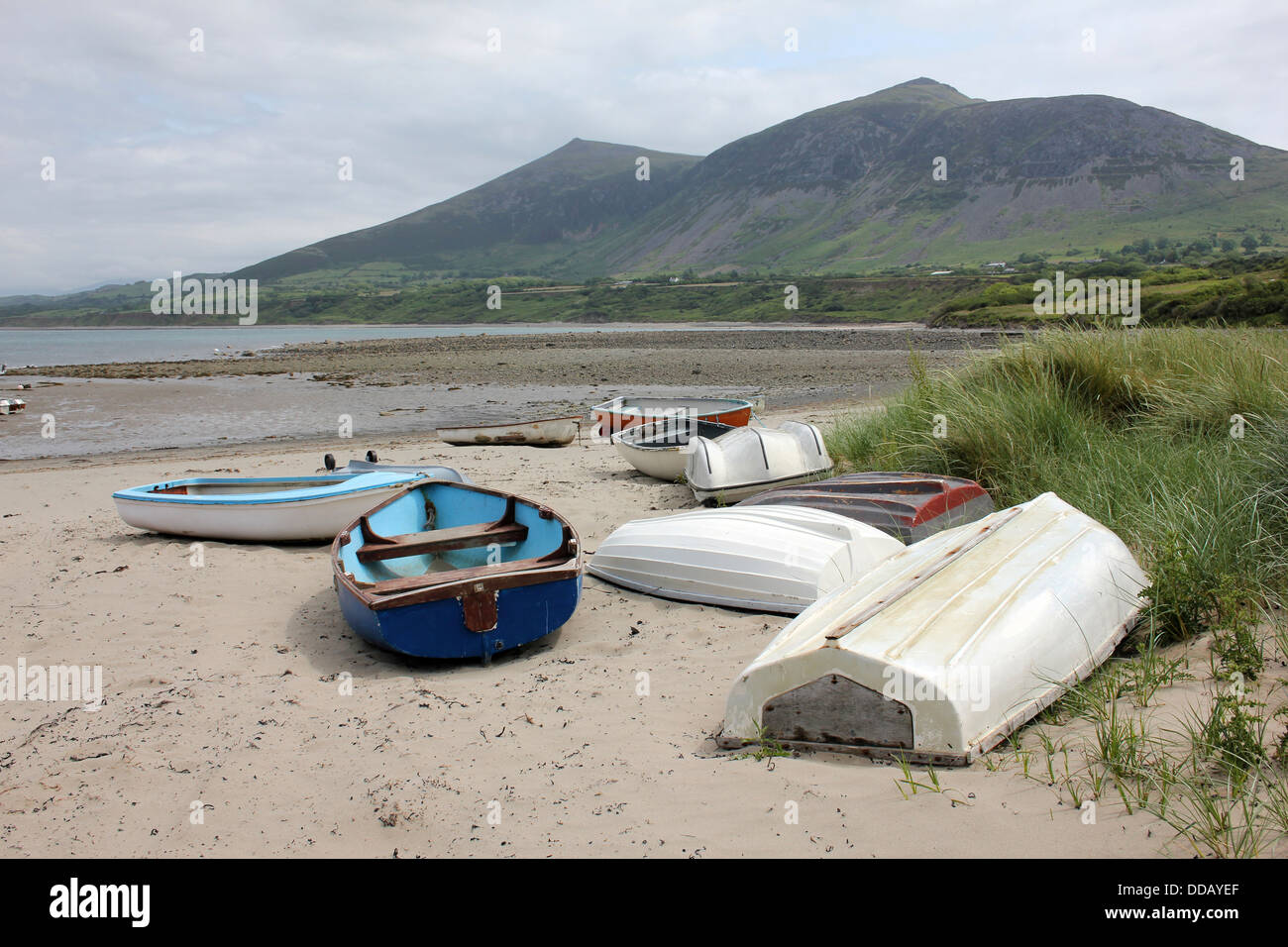 Barche di bolina fino sulla spiaggia di Trefor, che giace ai piedi di Yr Eifl, le colline più alte sulla penisola di Llyn, Galles Foto Stock