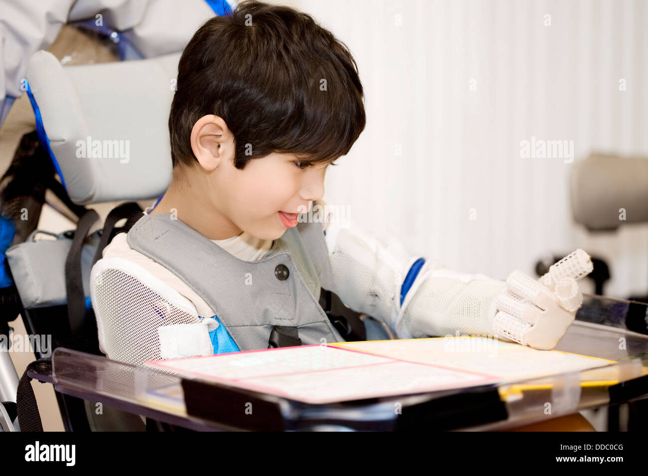 Cinque anni ragazzo di disabili che studiano in carrozzella Foto Stock