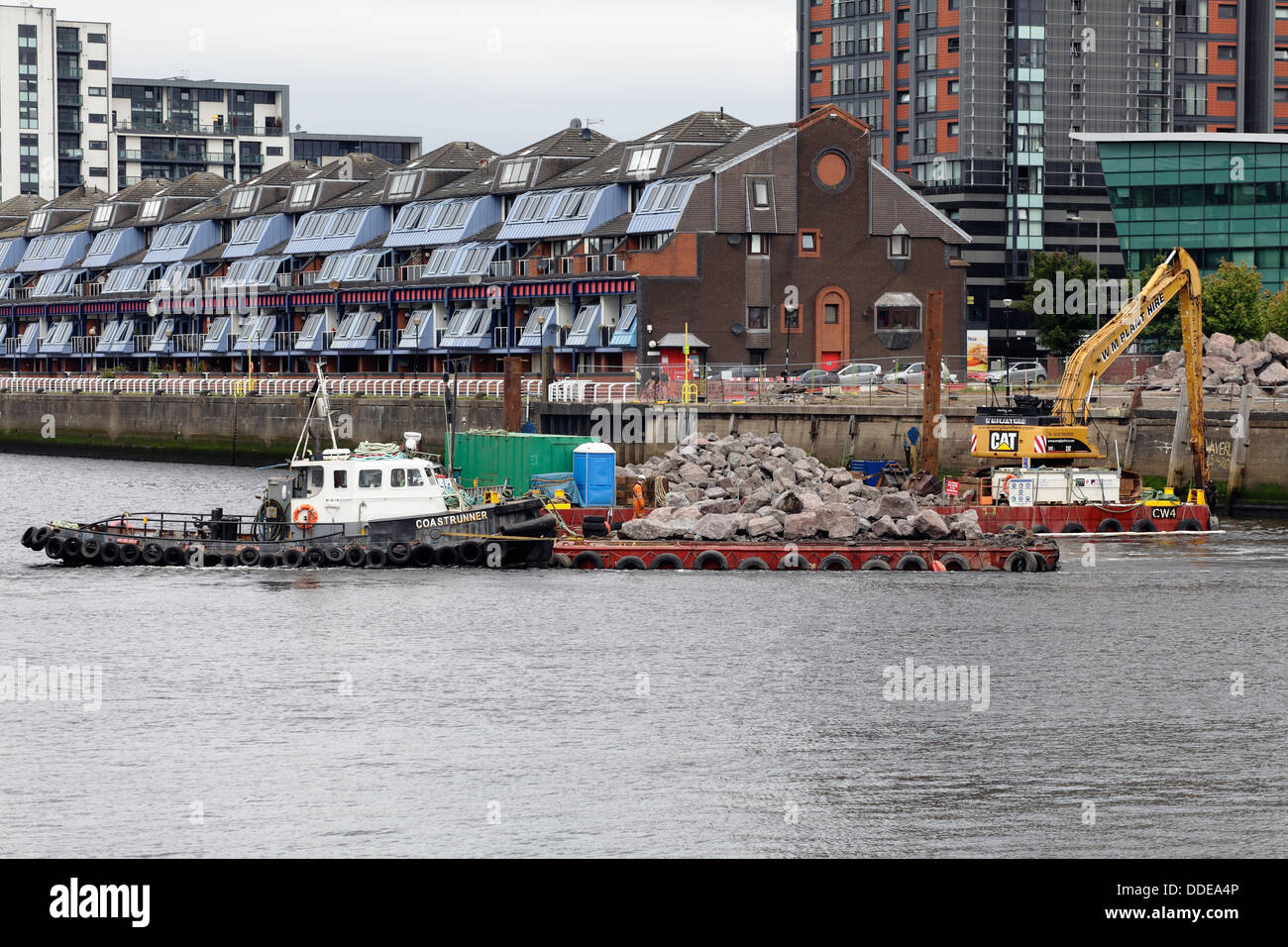 Lavori in corso per riparare la passerella crollata a Anderston Quay sul fiume Clyde utilizzando un digger che lavora da una chiatta a Glasgow, Scozia, Regno Unito Foto Stock
