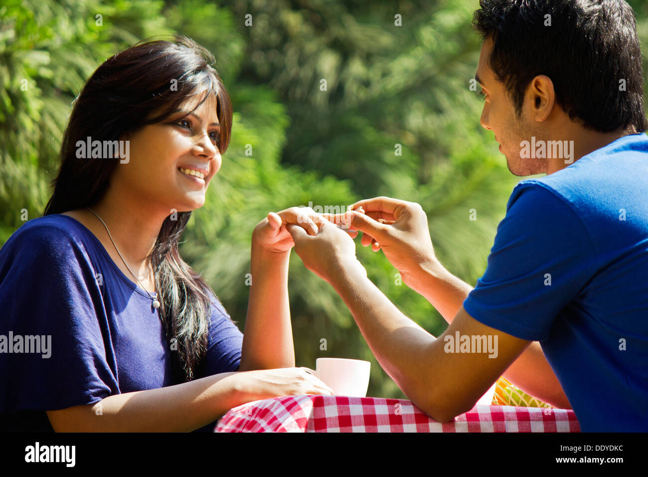 L'uomo immissione anello di fidanzamento sul dito womans Foto Stock