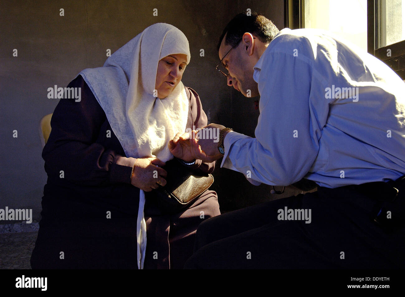 Un volontario arabo israeliano dei PHR Medici per i diritti umani che controllano una donna palestinese durante una visita DI clinica mobile PHR nella Cisgiordania Israele Foto Stock