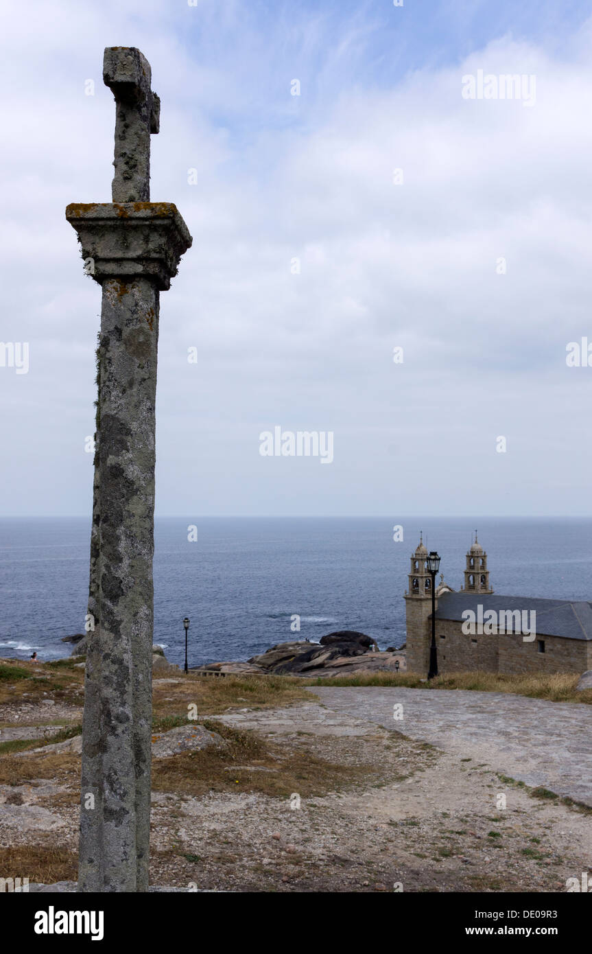 Una croce di pietra, una croce tipico modo di San Giacomo, si trova vicino alla chiesa di Santa Maria nella città di Muxia. Foto Stock