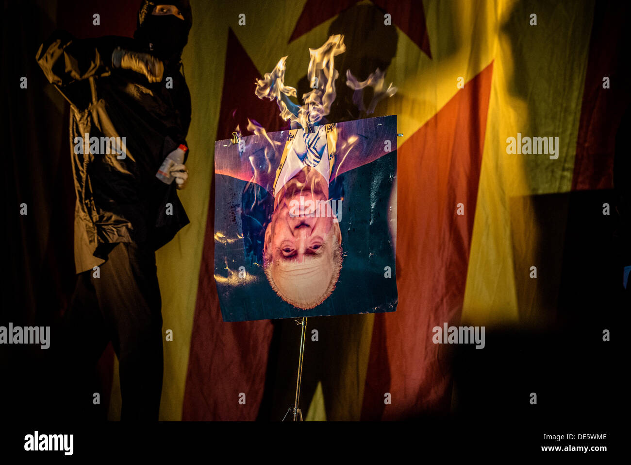 Barcellona, Spagna. Settembre 11th, 2013: mascherato pro-indipendenza attivisti masterizzare una foto di Juan Carlos alla fine di una dimostrazione sulla Catalogna della giornata nazionale © matthi/Alamy Live News Foto Stock