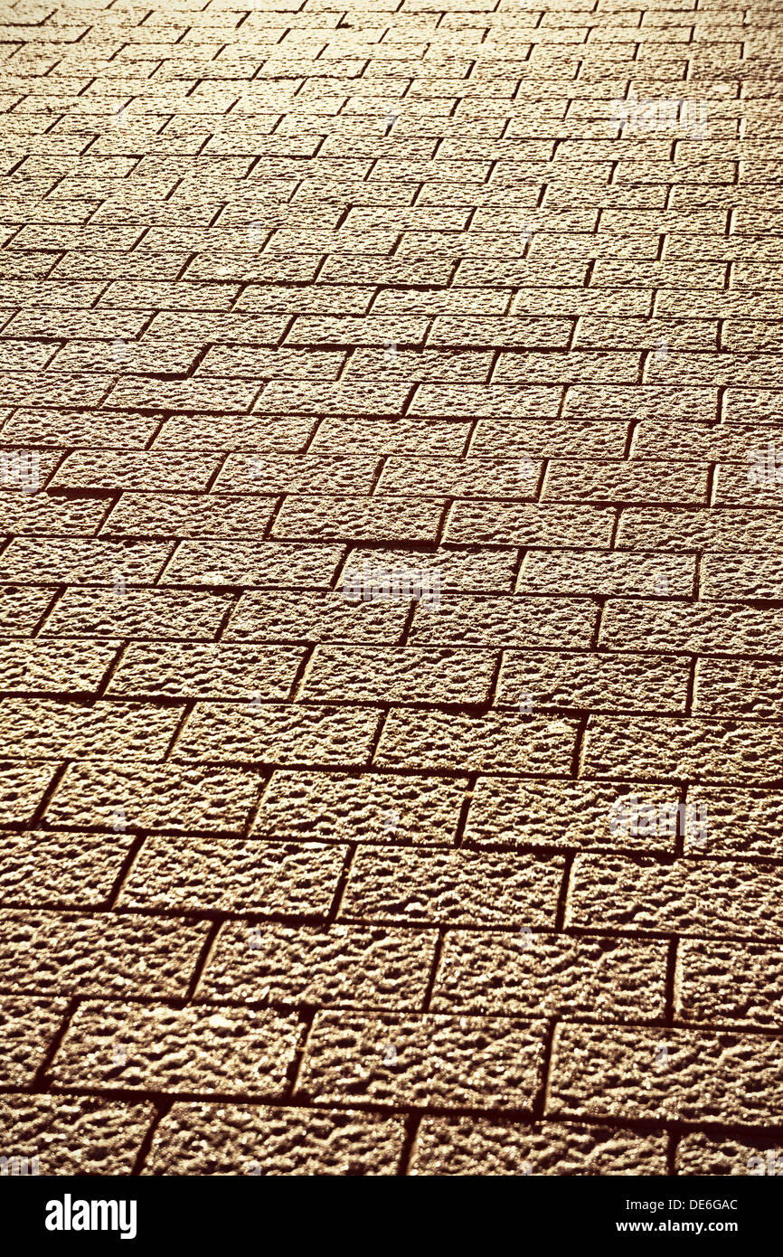 Sullo sfondo di un marciapiede con pietre per pavimentazione Foto Stock