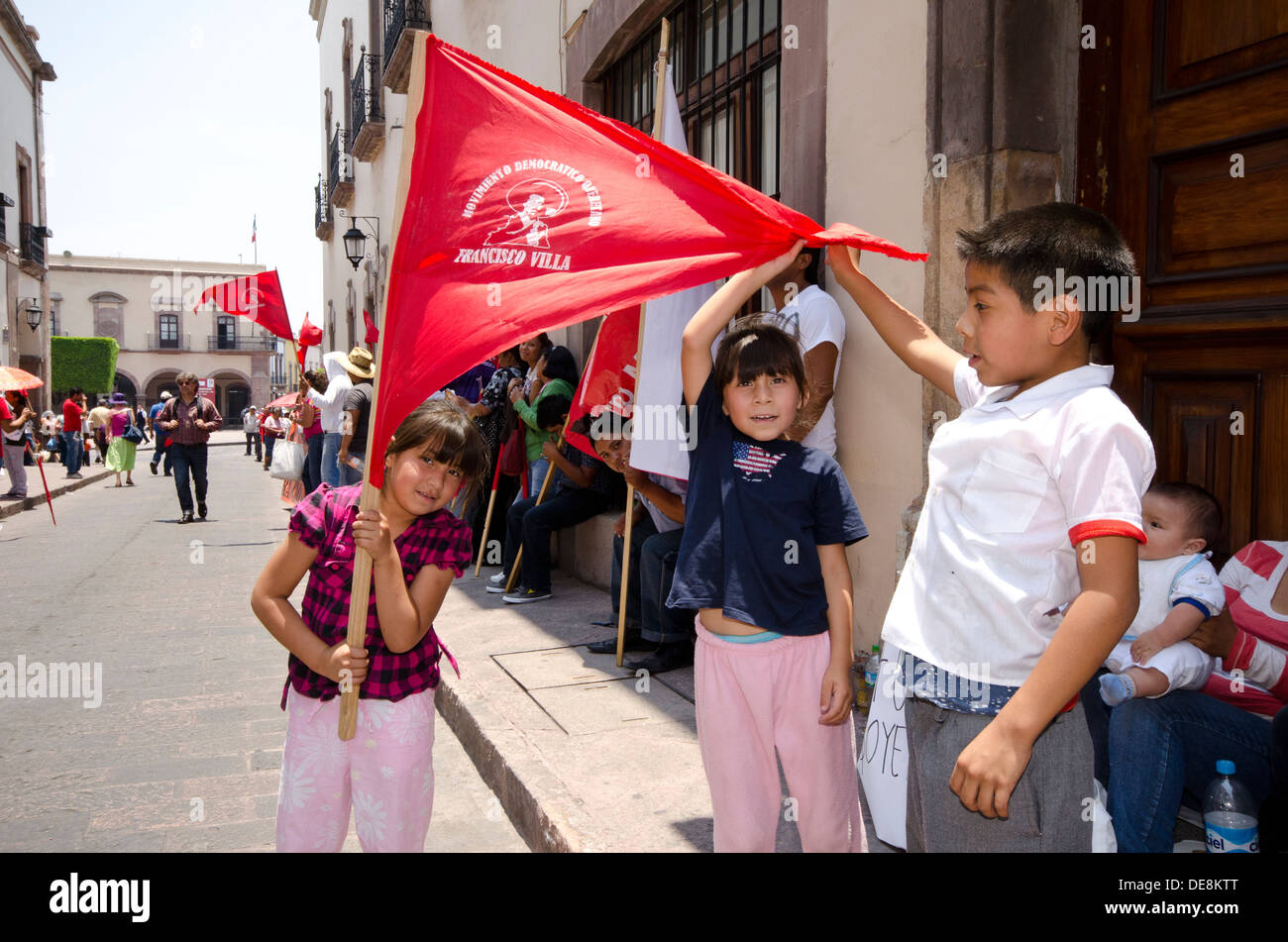 I bambini in possesso di un banner nel corso di una protesta di strada per le strade della città di Queretaro, Messico. Foto Stock