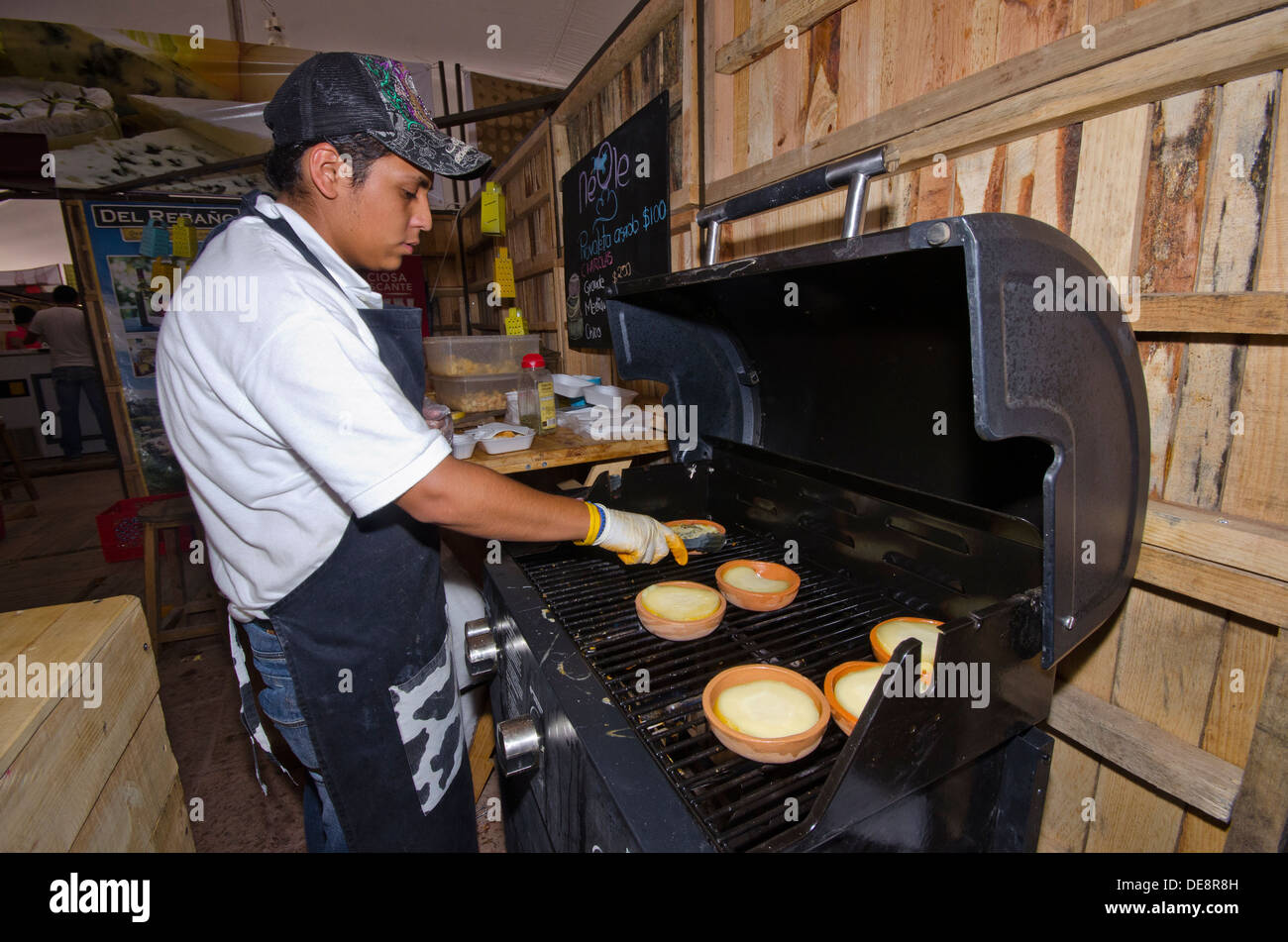 L'uomo riscaldamento torte al formaggio internazionale e il festival del vino in Tequisquiapan nello stato di Queretaro in Messico Foto Stock