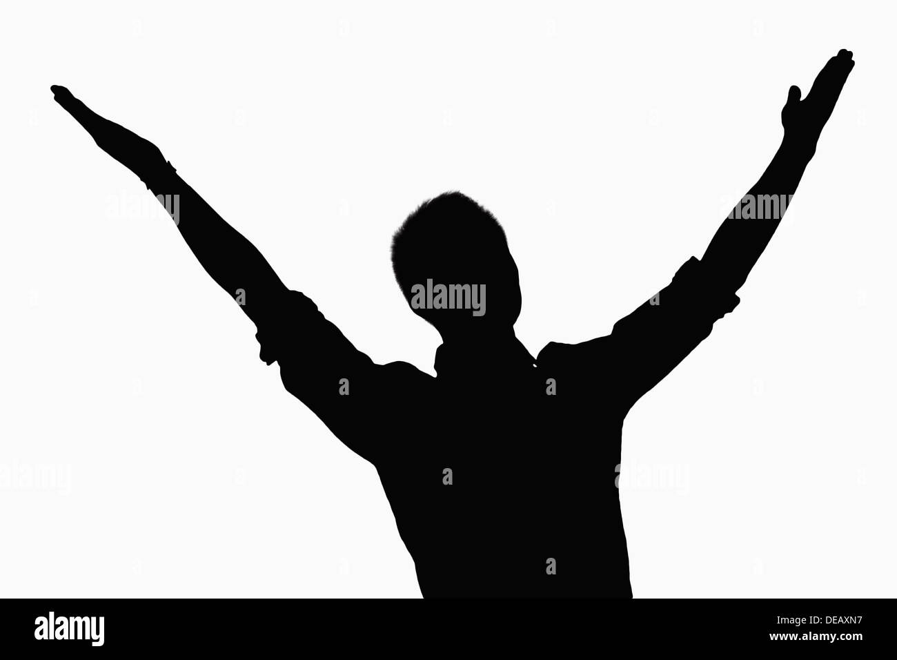 Silhouette di un imprenditore con bracci sollevati. Foto Stock