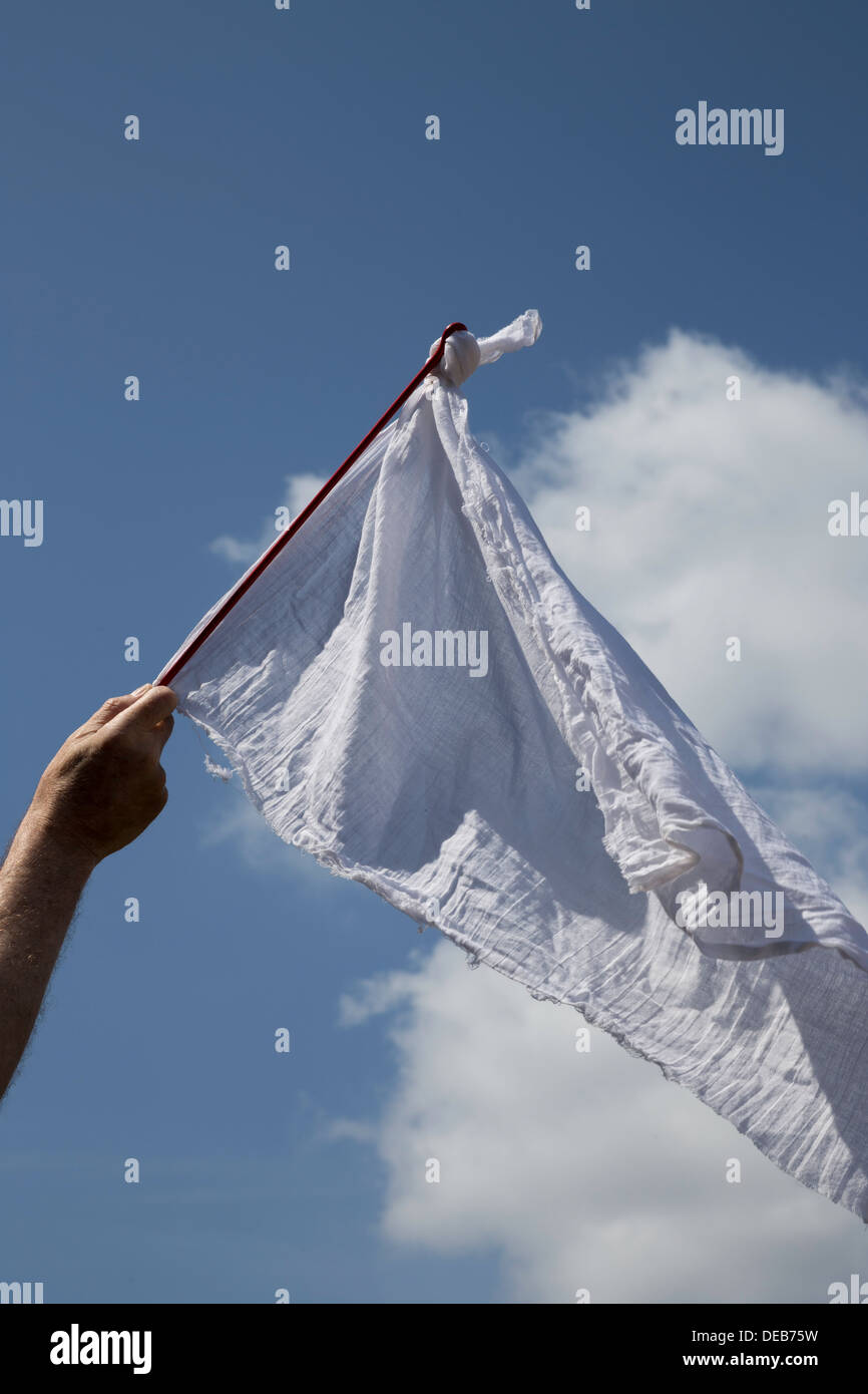 Bandiera bianca sventolata arrendersi contro il cielo blu Foto Stock