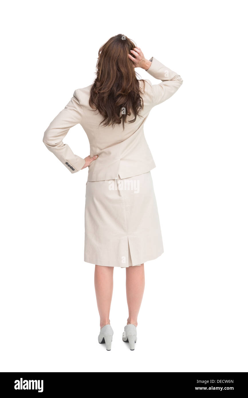 Imprenditrice standing torna alla telecamera con la mano sulla testa Foto Stock