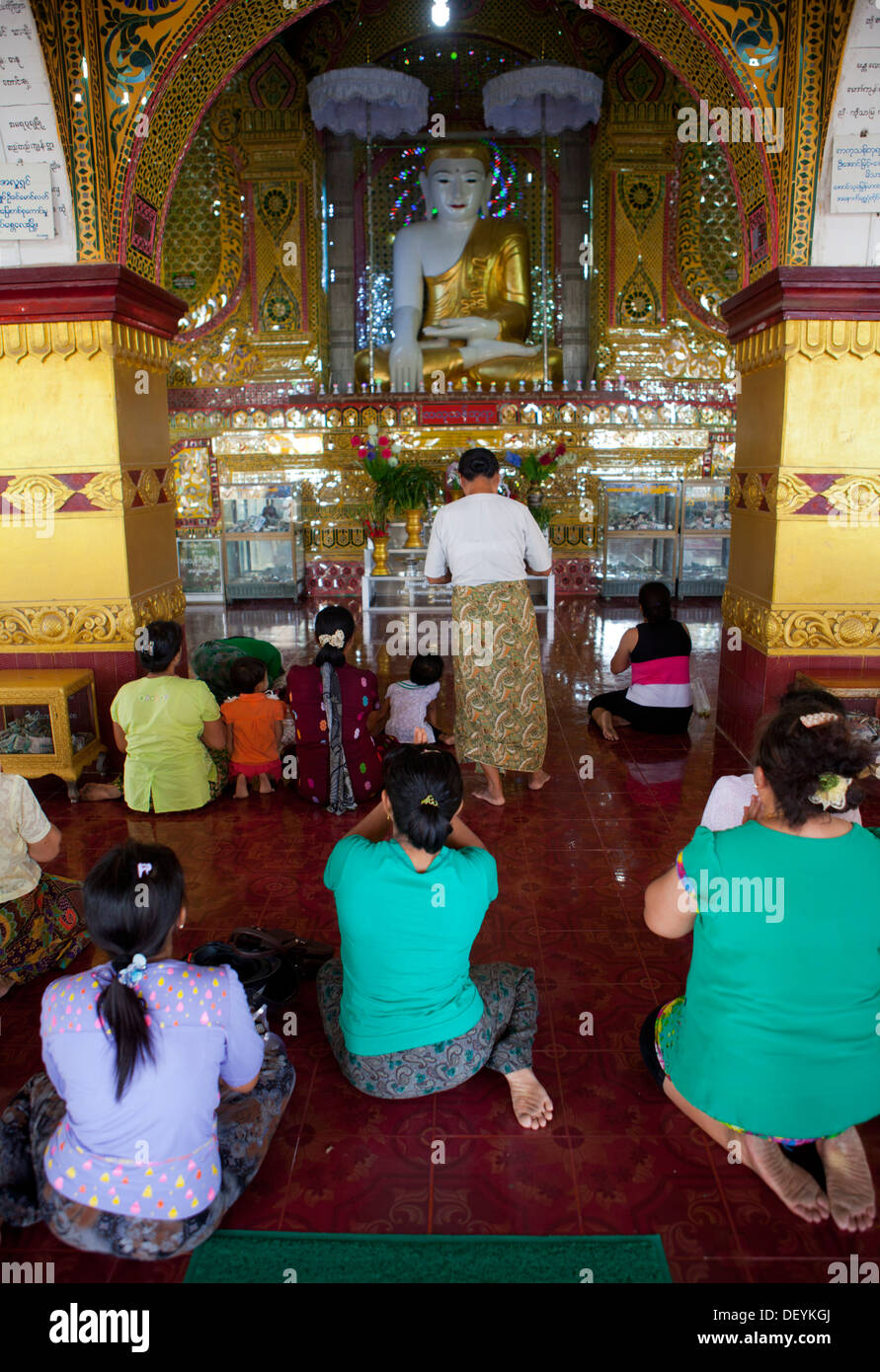 Persone che pregano in un tempio buddista sulla sommità del Mandalay Hill. Foto Stock