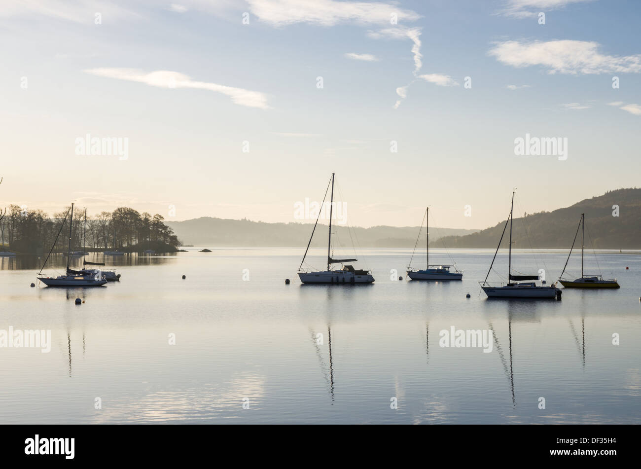 Una bella scena su un lago con acqua calma e yacht barche riflessioni. mattina di sole. lontane colline. Foto Stock
