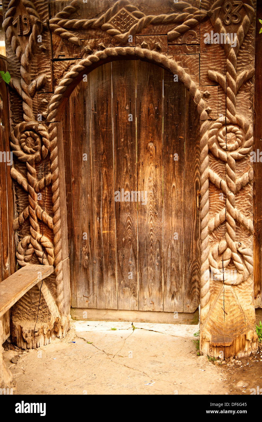 Xix secolo Iza tradizionale Valley farm house in legno scolpito arte popolare cancelli, il museo del villaggio vicino Sighlet, Maramures, Norther Foto Stock