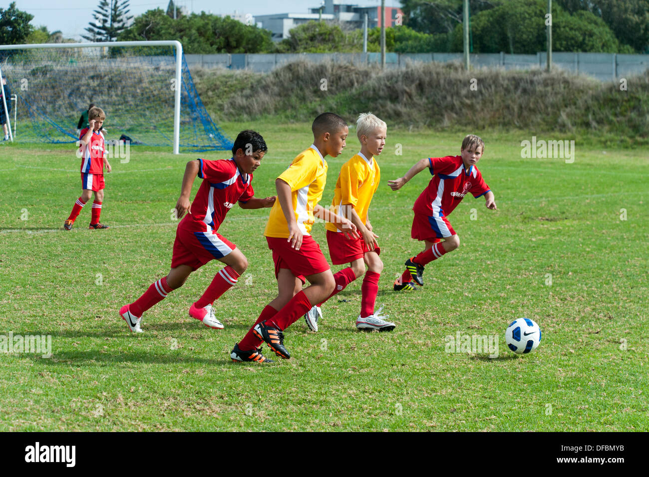 Junior football giocatori inseguono il pallone, Cape Town, Sud Africa Foto Stock