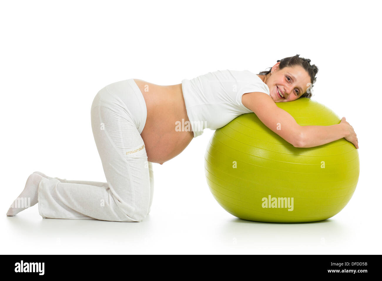 Donna incinta praticare esercizi di montare la sfera isolato Foto Stock