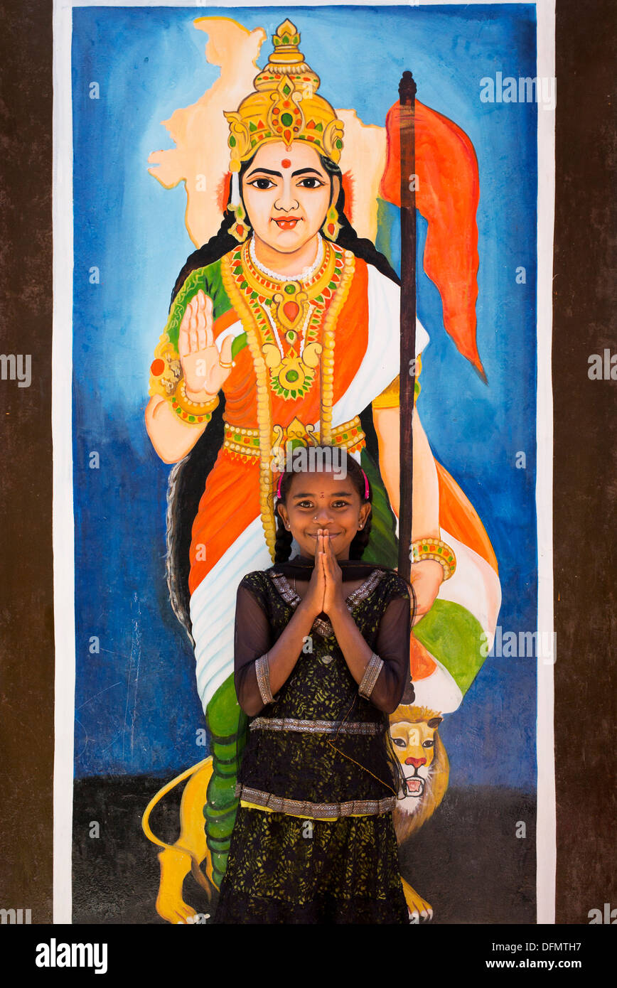 Ragazza indiana in piedi di fronte alla Madre India / pittura murale a parete in corrispondenza di una zona rurale villaggio indiano scuola. Andhra Pradesh, India Foto Stock
