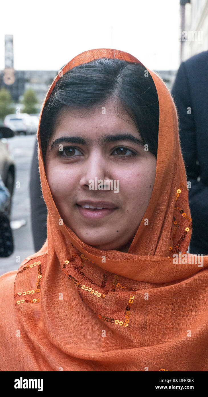 New York, Stati Uniti d'America. 08 ott 2013. Malala Yousafzai schoolgirl pakistano attivista di istruzione delle pause per firmare copie del suo libro, "io sono Malala: La ragazza che si alzò per istruzione e fu ucciso dai talebani", come lei arriva per comparsa sul Daily Show con Jon Stewart. La città di New York, Martedì, 8 ottobre 2013, STATI UNITI D'AMERICA. Credito: Dorothy Alexander/Alamy Live News Foto Stock