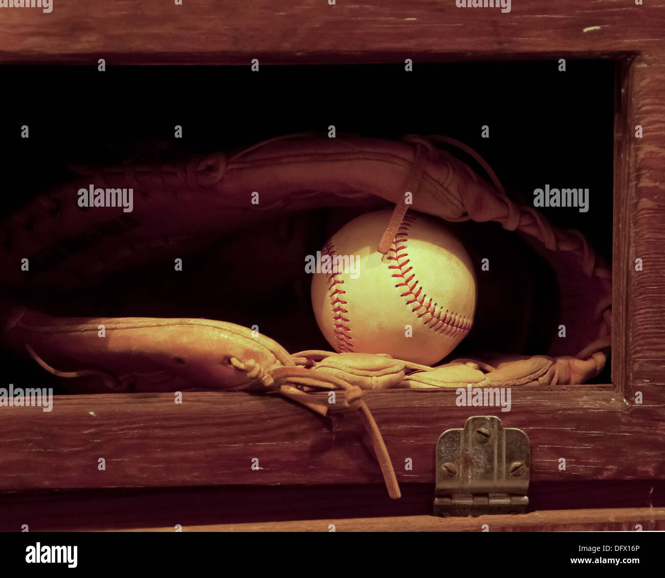 Un baseball in un guanto seduto in un vecchio cabinet. Foto Stock