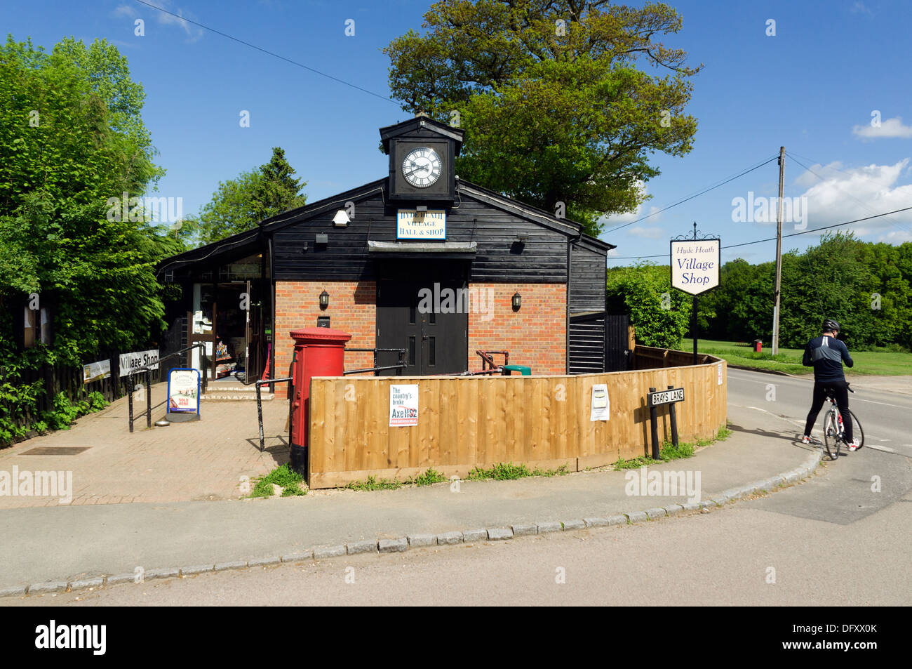 Maschio singolo ciclista fuori Hyde Heath village hall e locali negozio indipendente Bucks REGNO UNITO Foto Stock