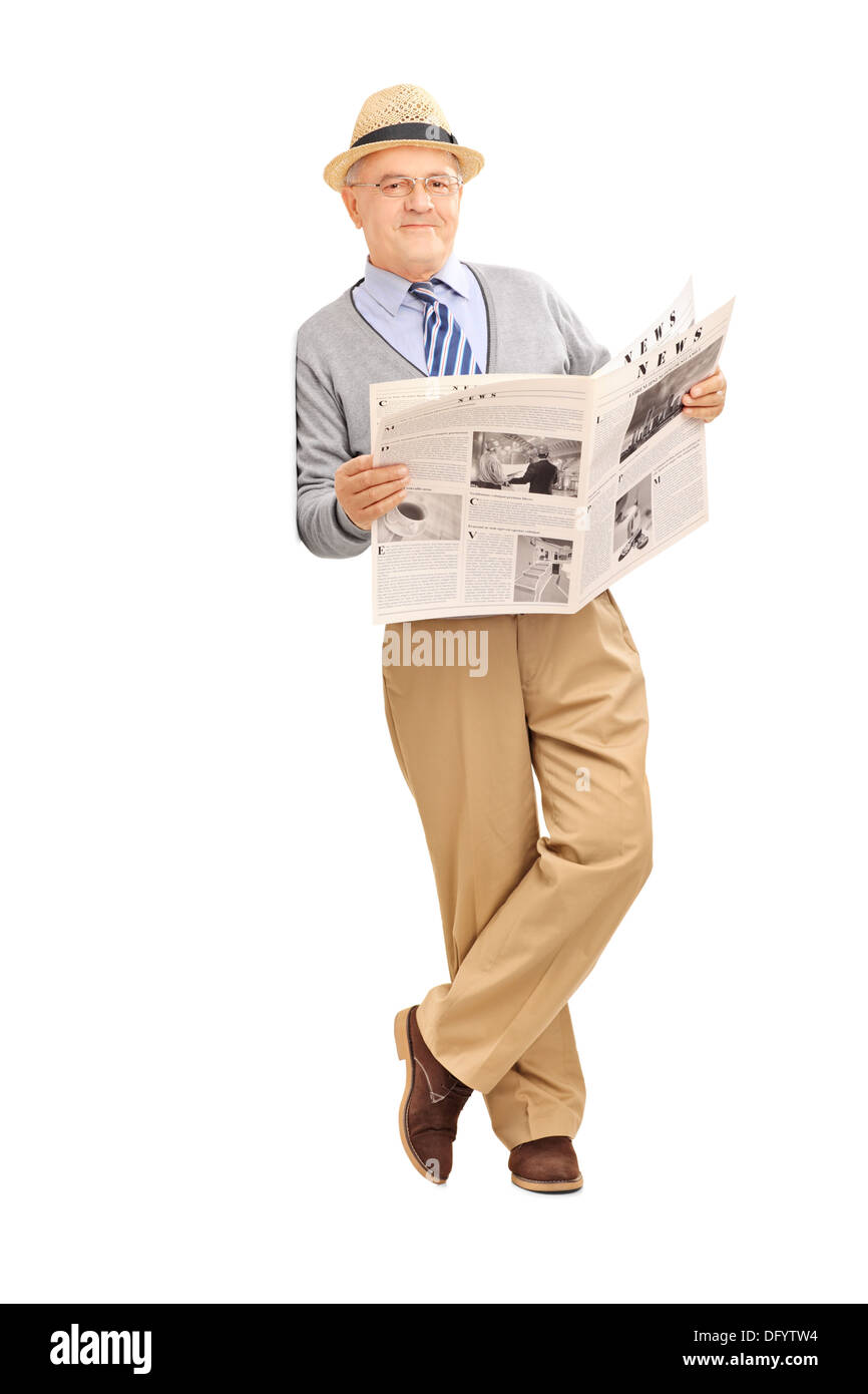 Senior gentleman tenendo un giornale e appoggiata contro una parete Foto Stock