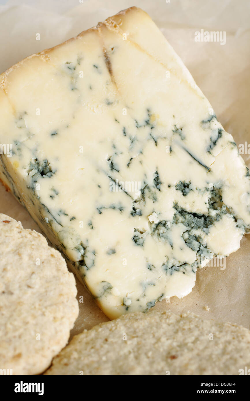 Del formaggio Stilton su di età compresa la carta pergamena con biscotti di avena Foto Stock
